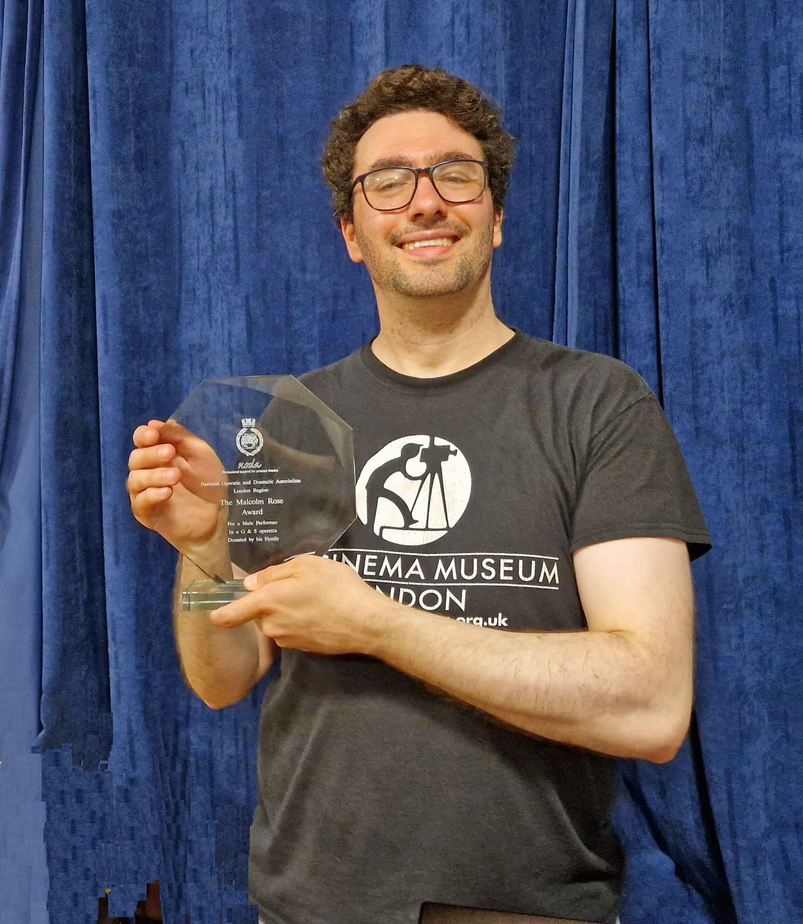 Alex displays his award